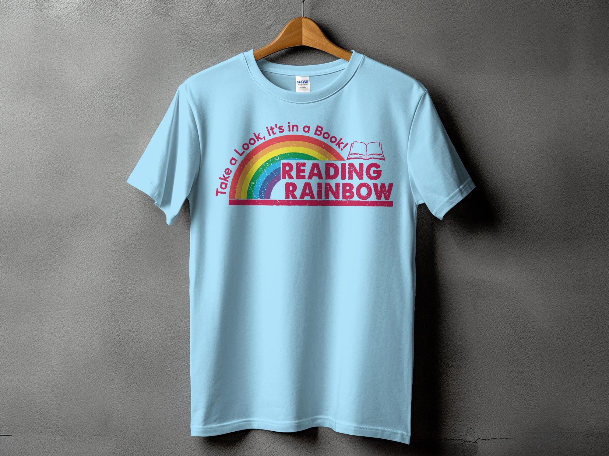 Light blue t-shirt with "Reading Rainbow" text and a rainbow graphic.