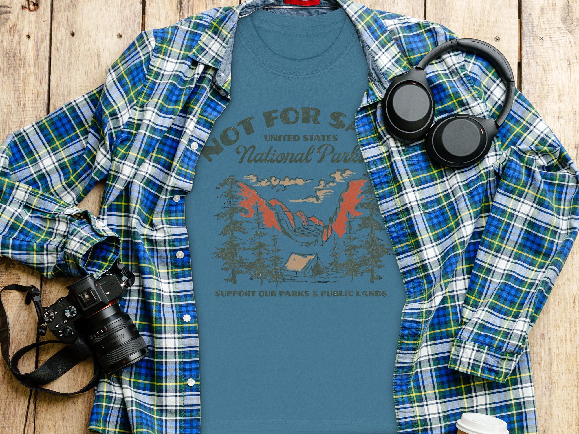 Blue t-shirt with "Not For Sale United States National Parks" text and camping graphic.