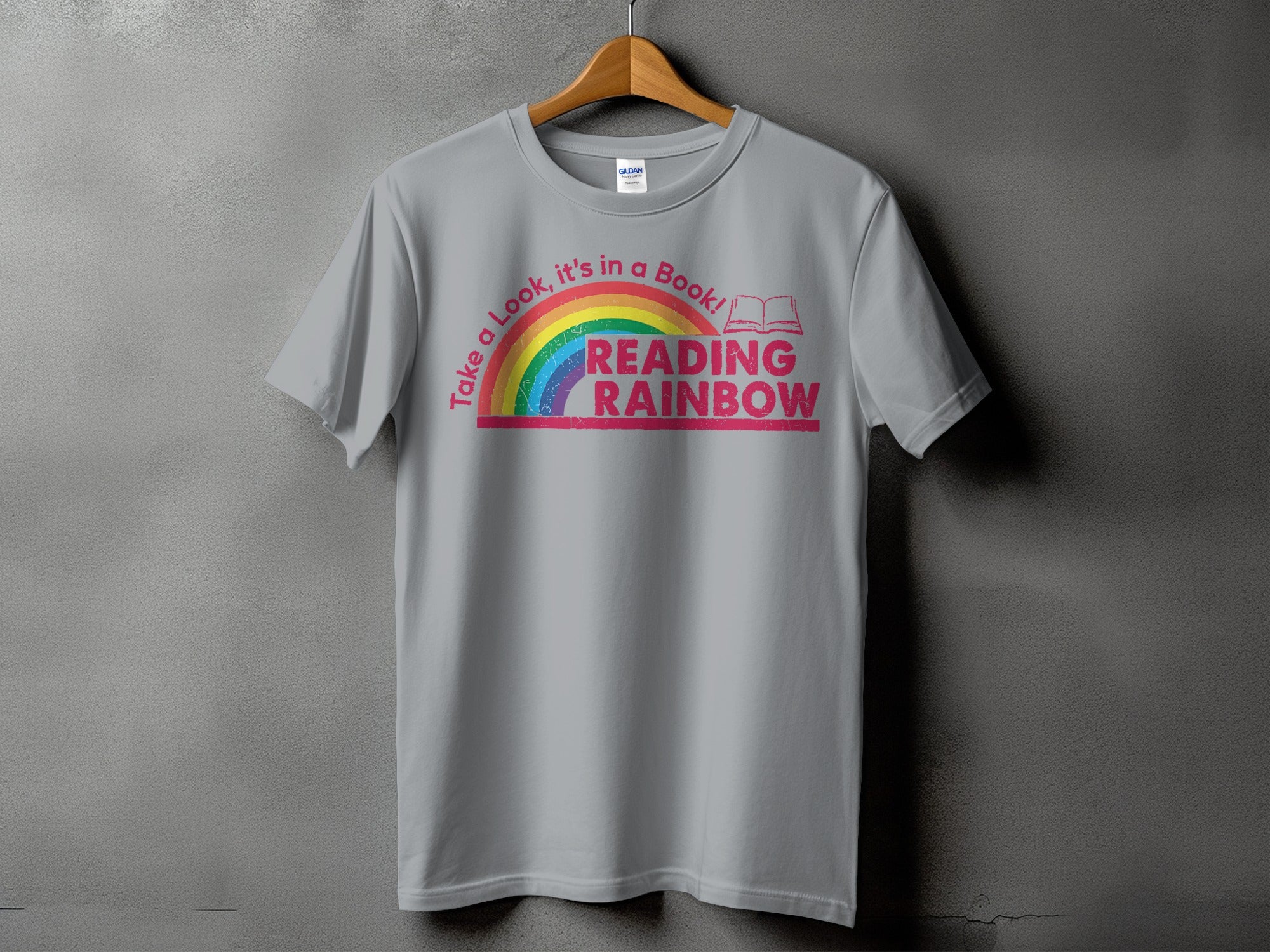 Gray t-shirt with rainbow graphic and text "Take a Look, it's in a Book! READING RAINBOW."