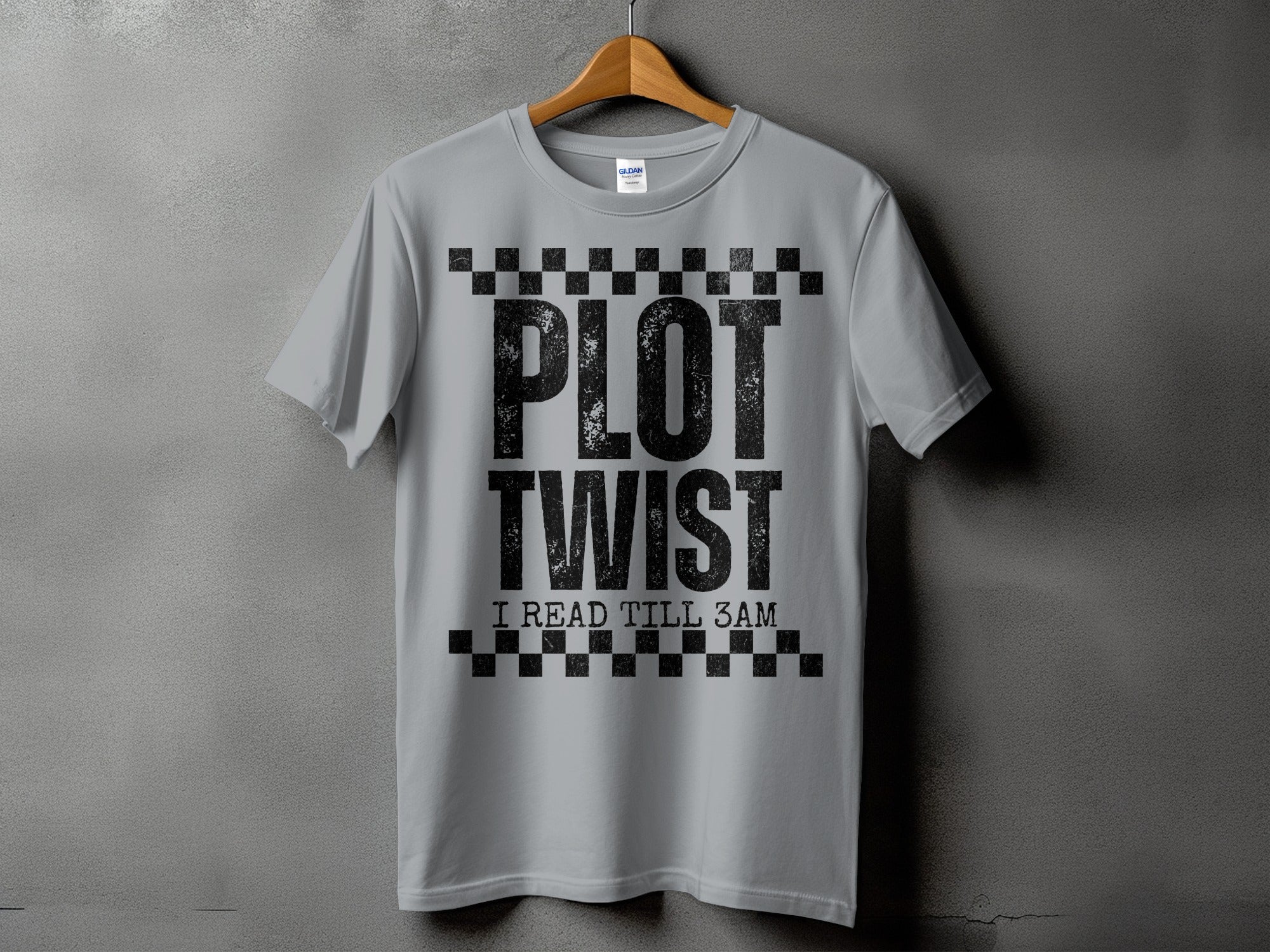 Grey t-shirt with "PLOT TWIST I READ TILL 3AM" text in black stencil font.