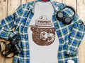 White t-shirt with brown bear graphic and text "Protect Our National Parks"