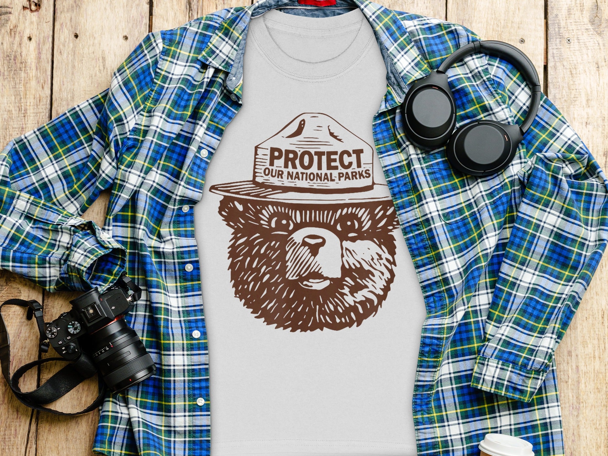 White t-shirt with brown bear graphic and text "Protect Our National Parks"