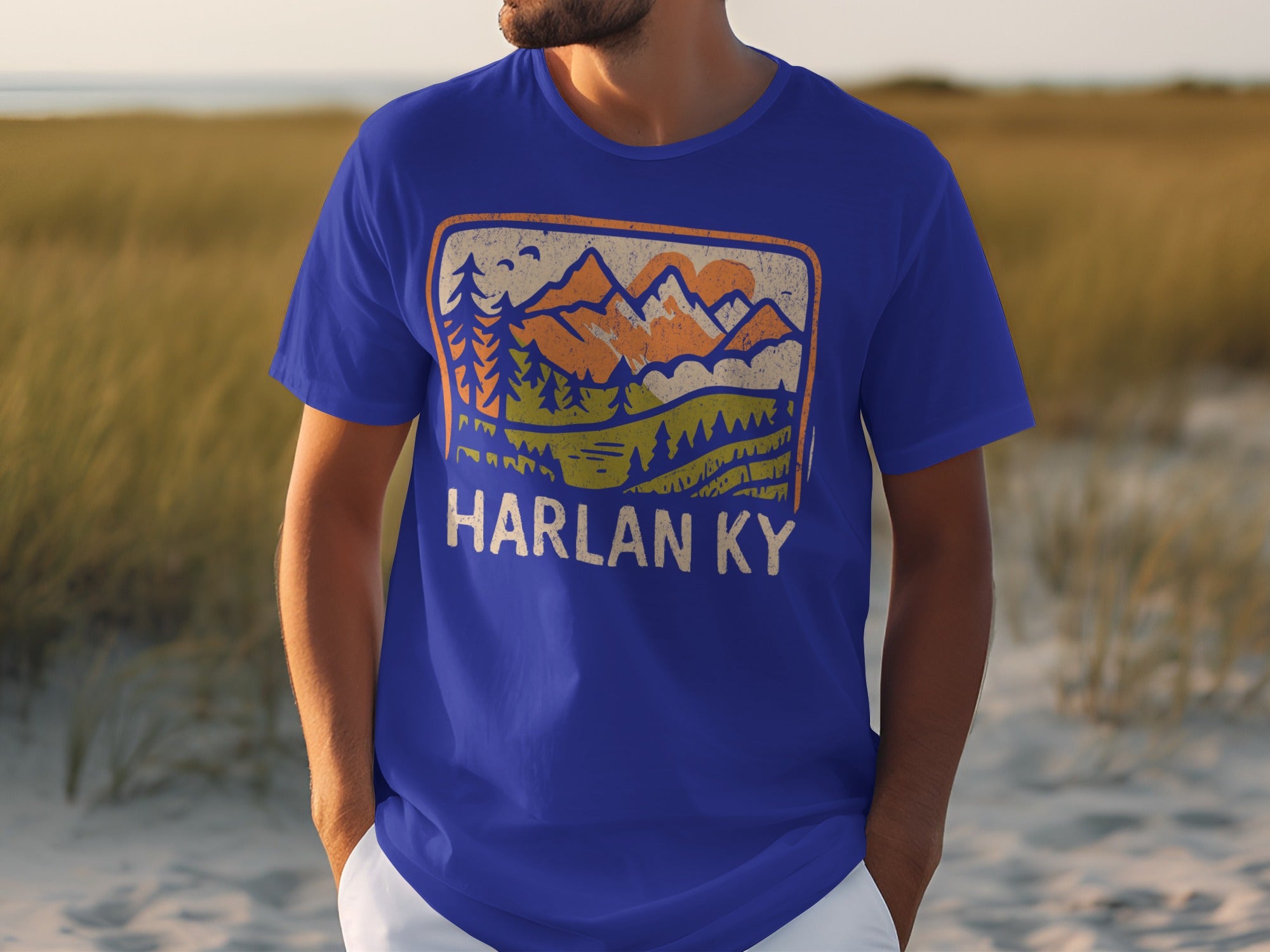 Blue t-shirt with vintage mountain landscape graphic and "HARLAN KY" text.